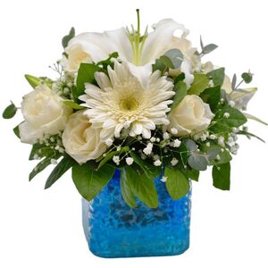 Glass cube in blue shades with fresh flowers