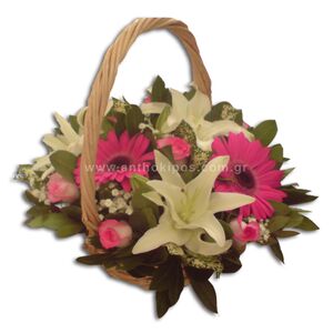 Flower arrangement in white-fuchsia color in basket with handle