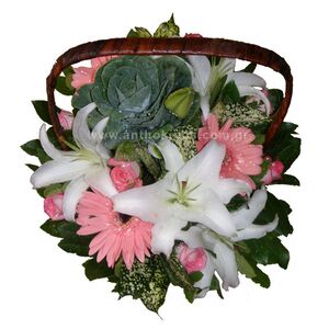 Flower arrangement in white-pink color in basket with handle