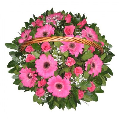 Flower arrangement in fuchsia shade in basket with handle