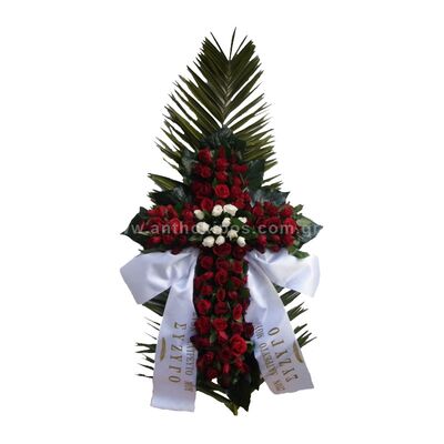 Funeral flowers cross with red roses