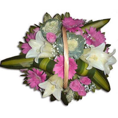 Flower arrangement in basket with handle in white-pink color