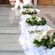 Εξωτερικός Στολισμός Γάμου με συνθέσεις λουλουδιών, κισσούς, πάνω σε λευκά υφάσματα