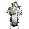 Funeral cross with two flower arrangements on tripod