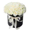 White roses in black hat box